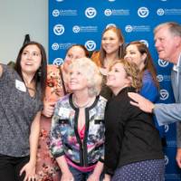 tom and marcia selfie with a big group of women